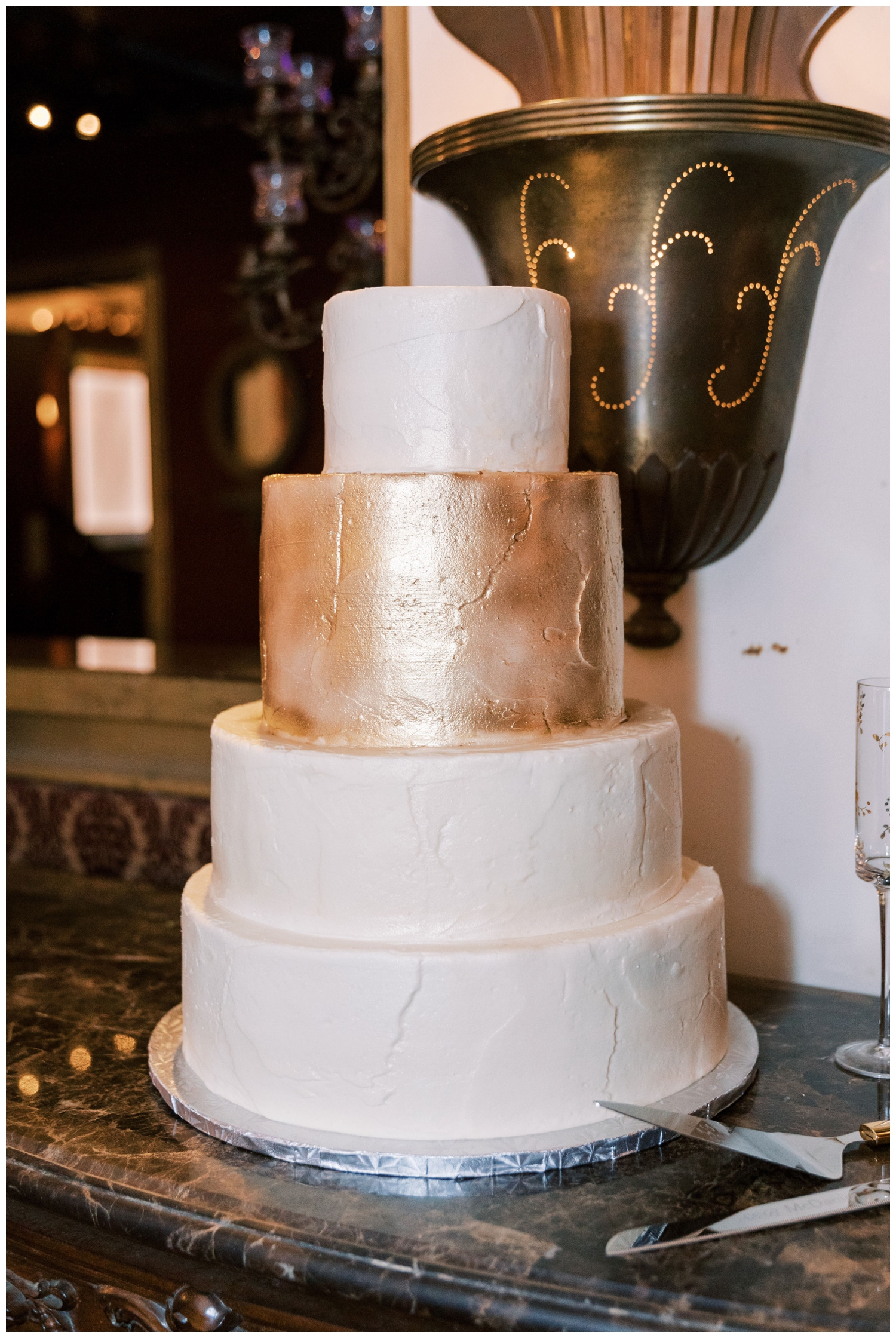 four tier white and gold wedding cake Majestic Metro Wedding