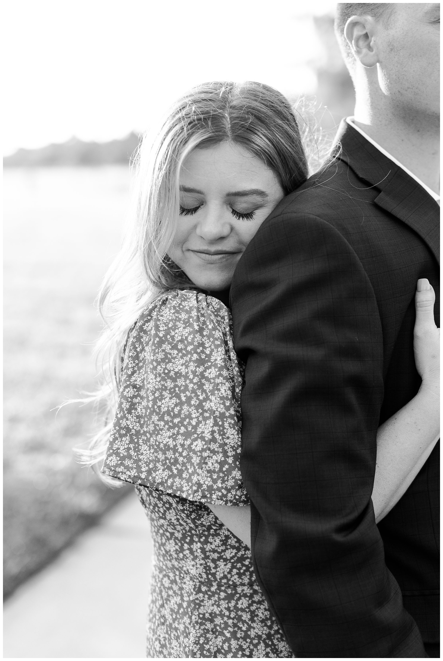 black and white closeup photo of engaged couple hugging