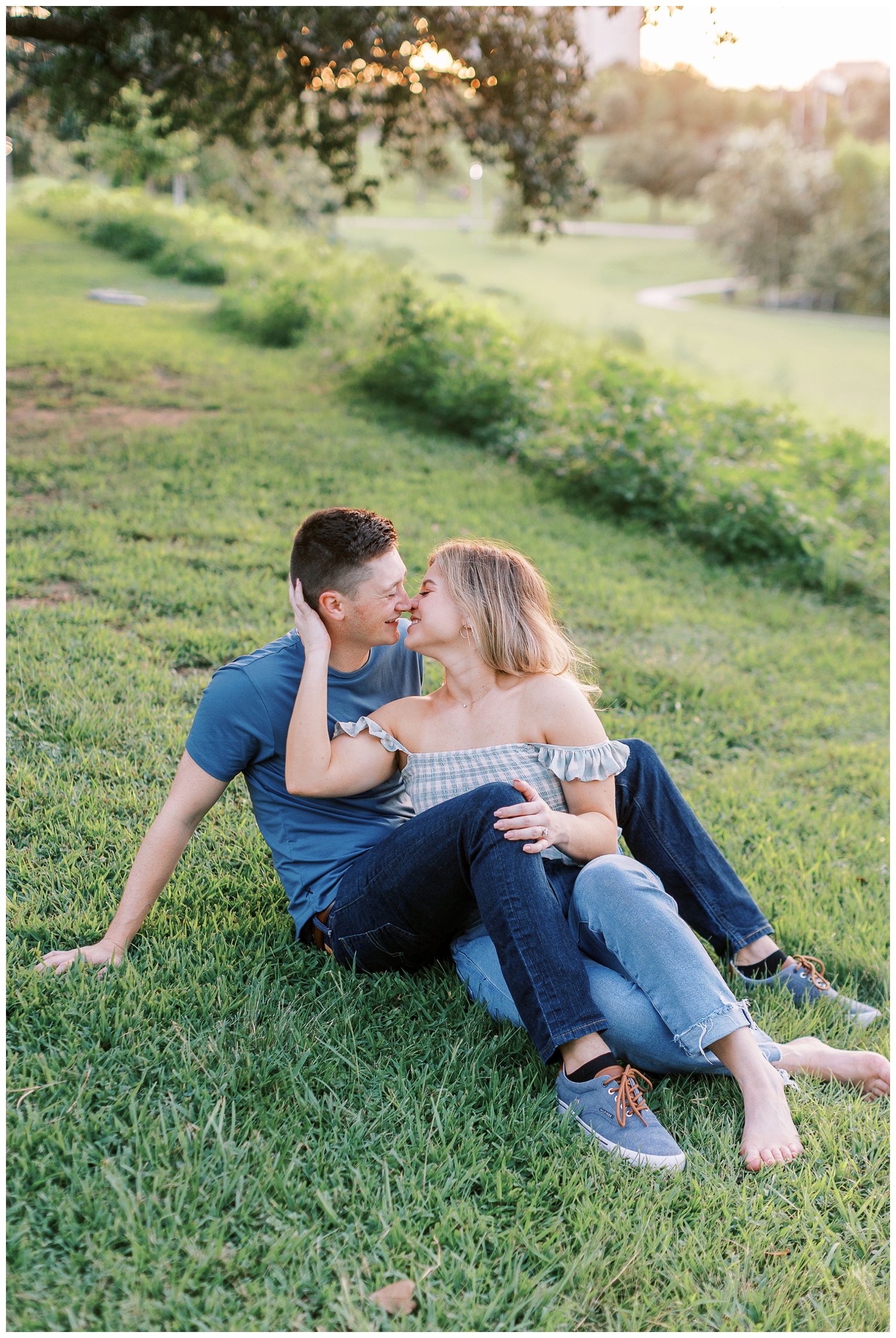 couple sitting on grassy hill Eleanor Tinsley engagement session