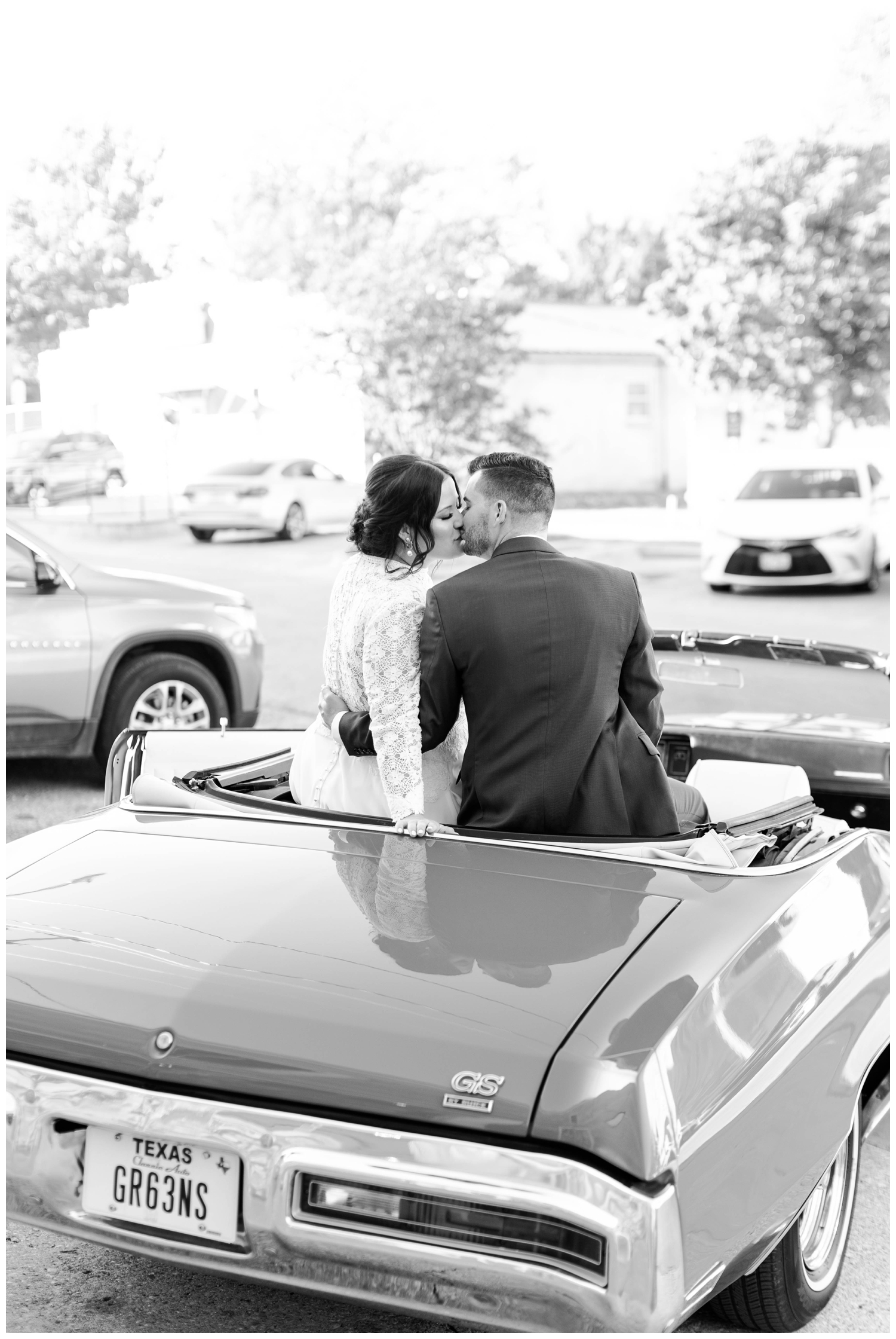 black and white portrait of bride and groom sitting in convertible outdoors in Austin Tetxas