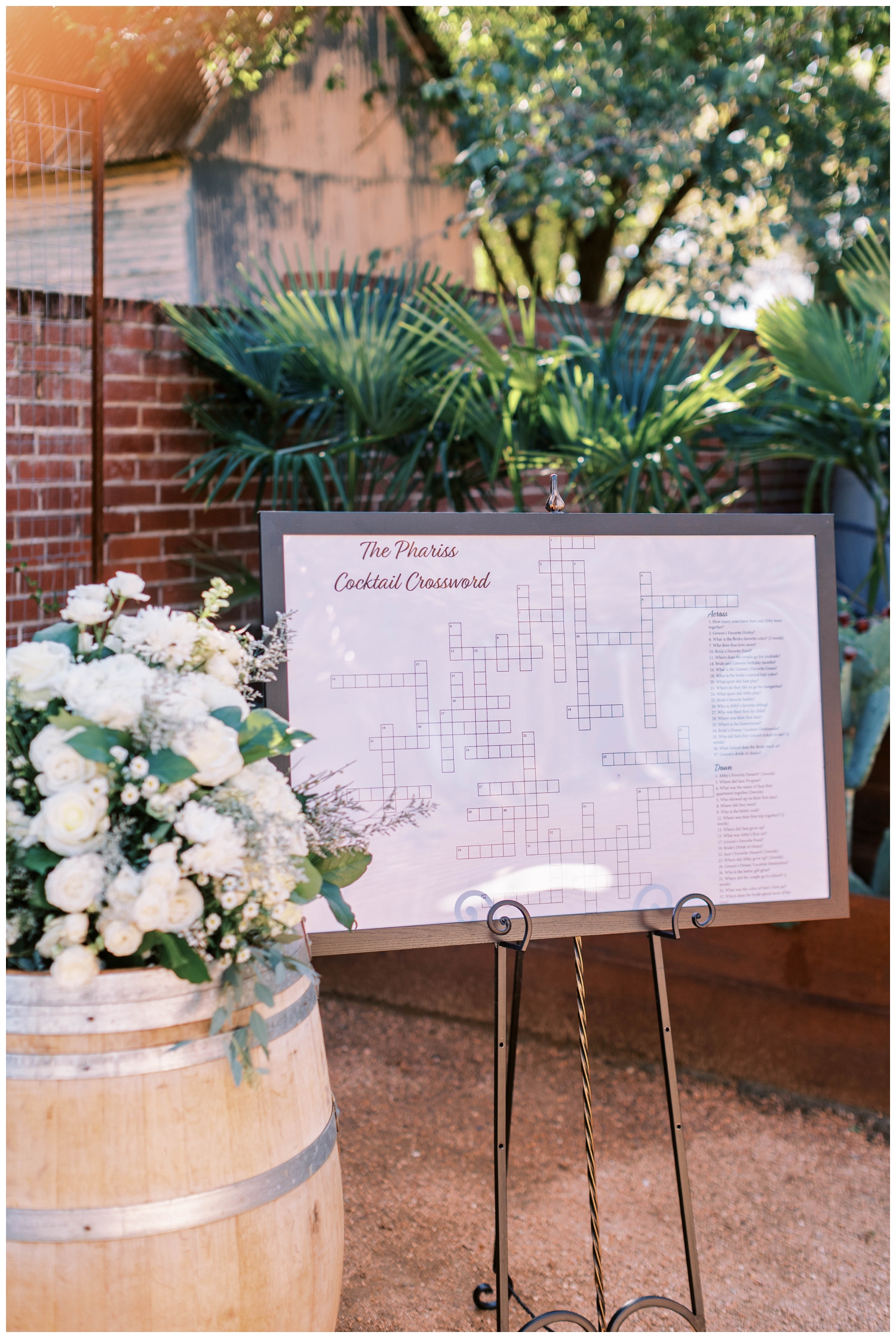 seating chart with white florals on top of a barrel