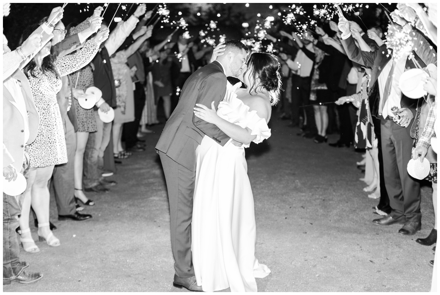 black and white image of bride and groom during sparkler exit