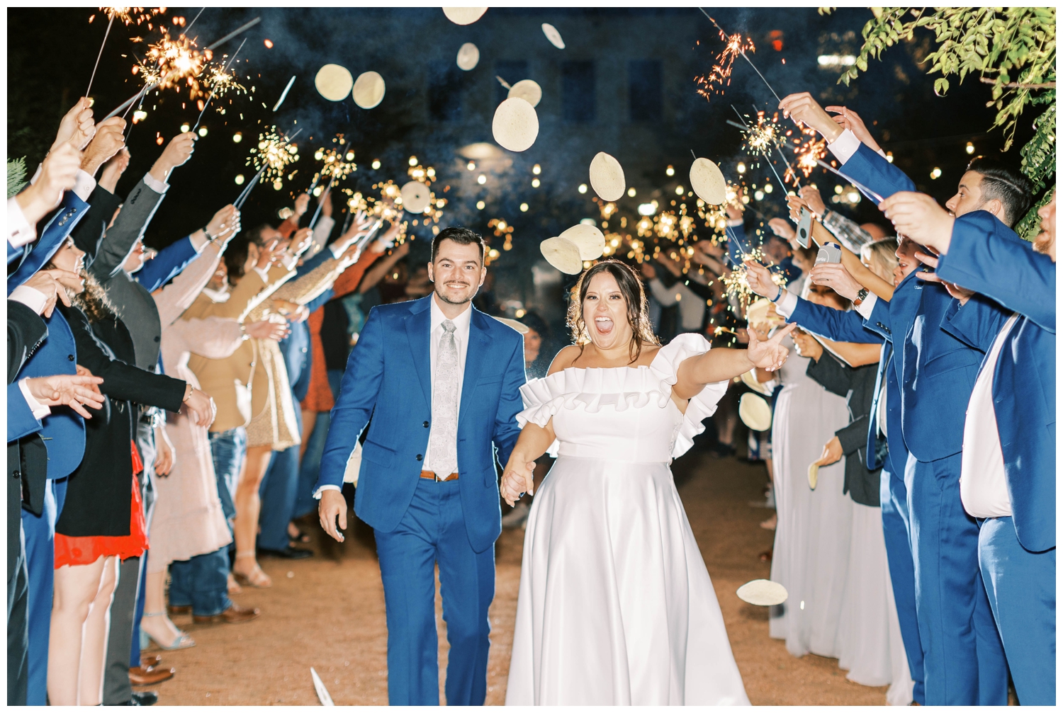 bride and groom running through sparkler exit and tortilla toss