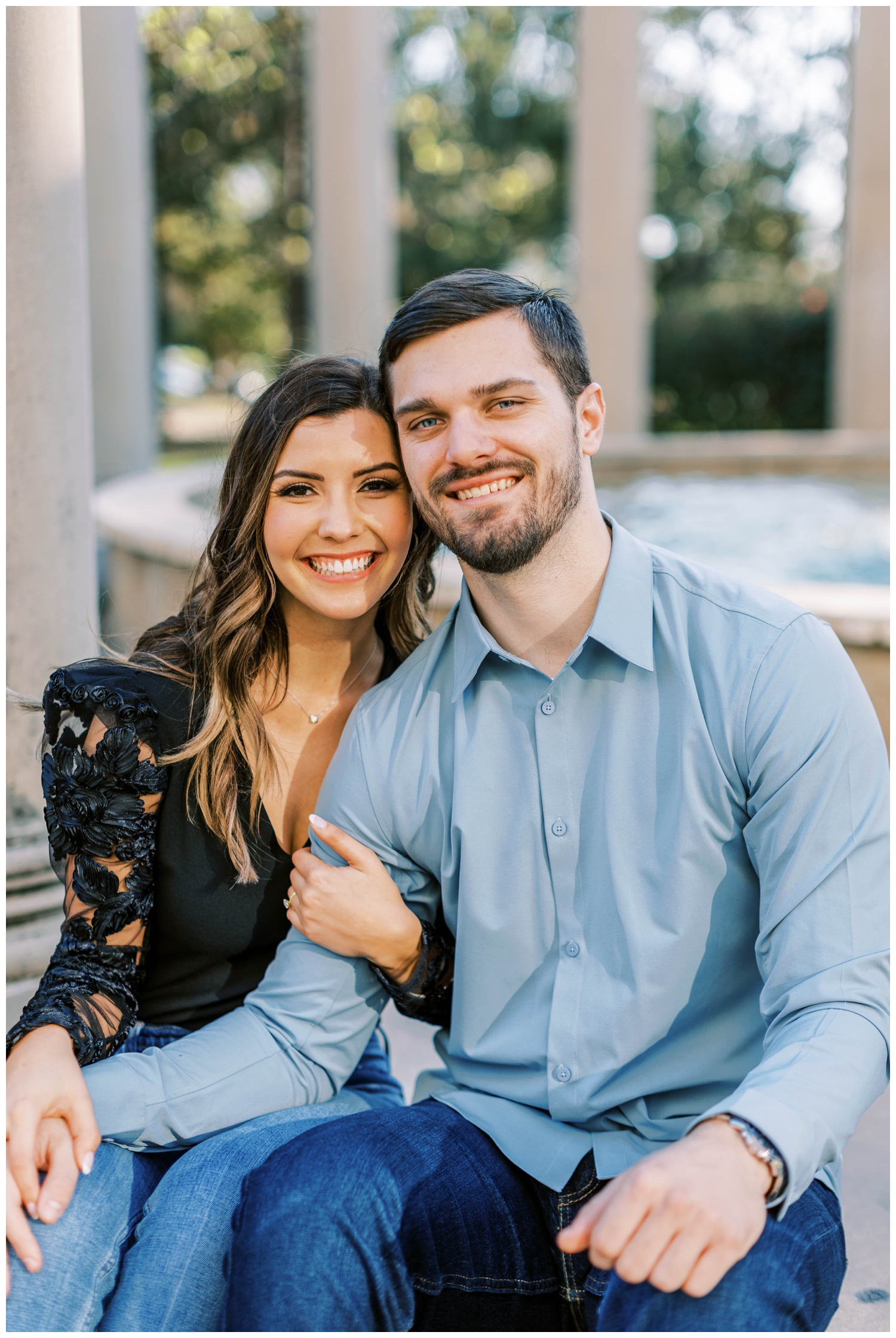 engaged couple sitting and smiling at Galveston Wedding Photographer