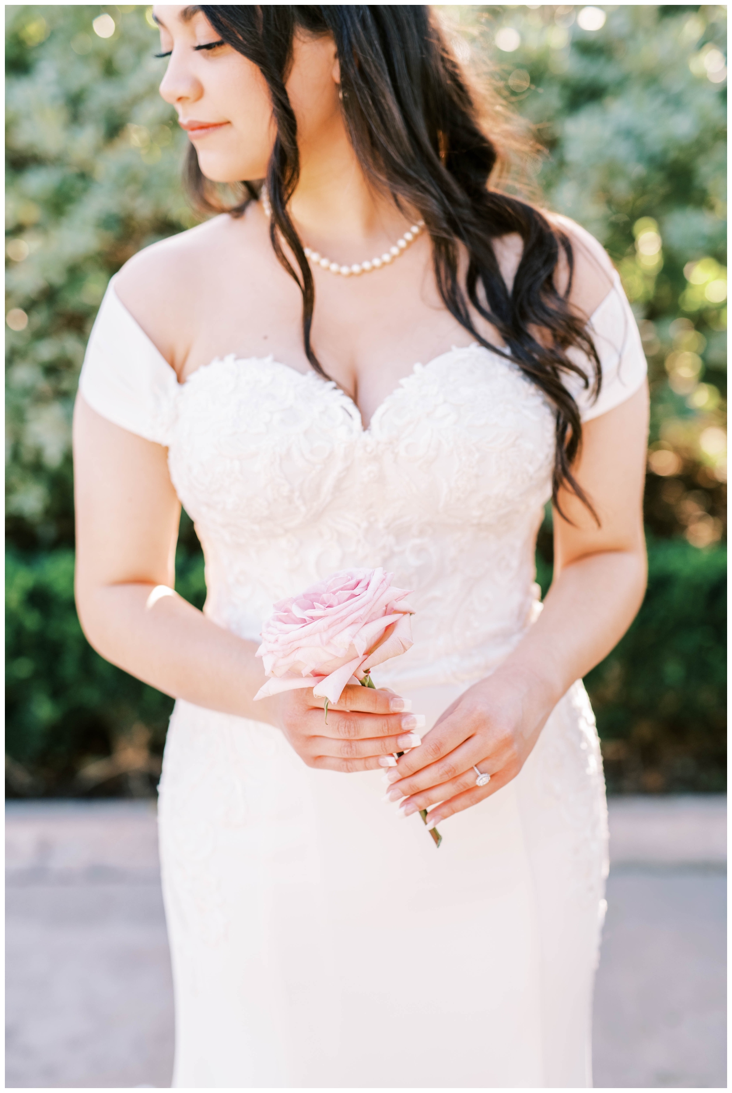 detailed portrait bride's hands holding pink rose