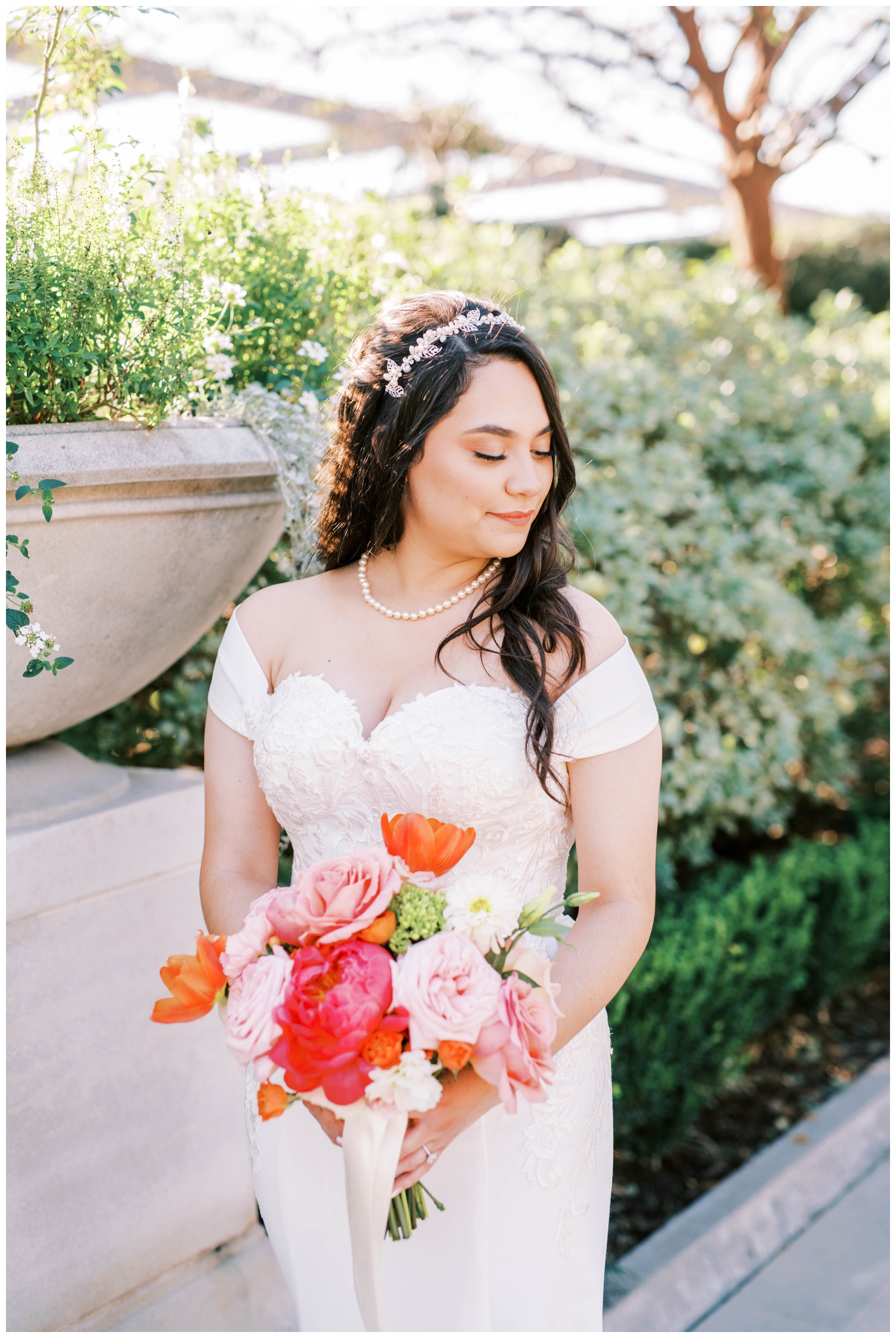 bride holding pink orange bouquet looking over shoulder McGovern Centennial Gardens Wedding
