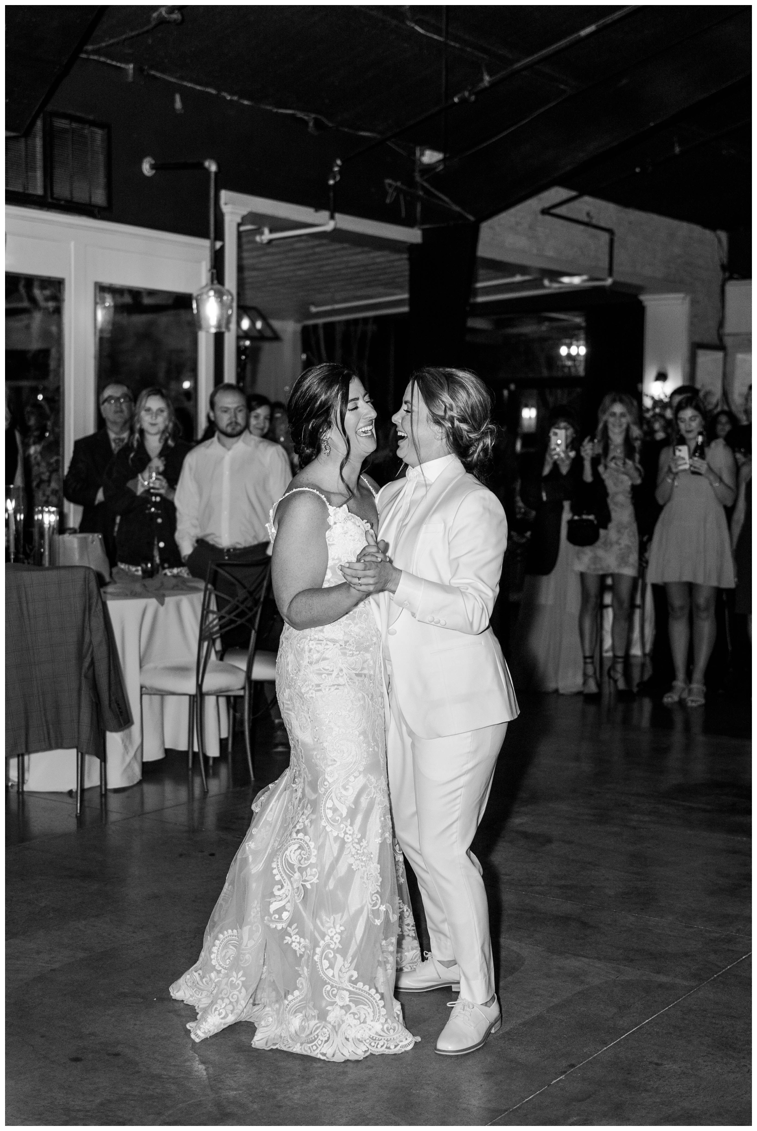 black and white image of bride and bride dancing reception
