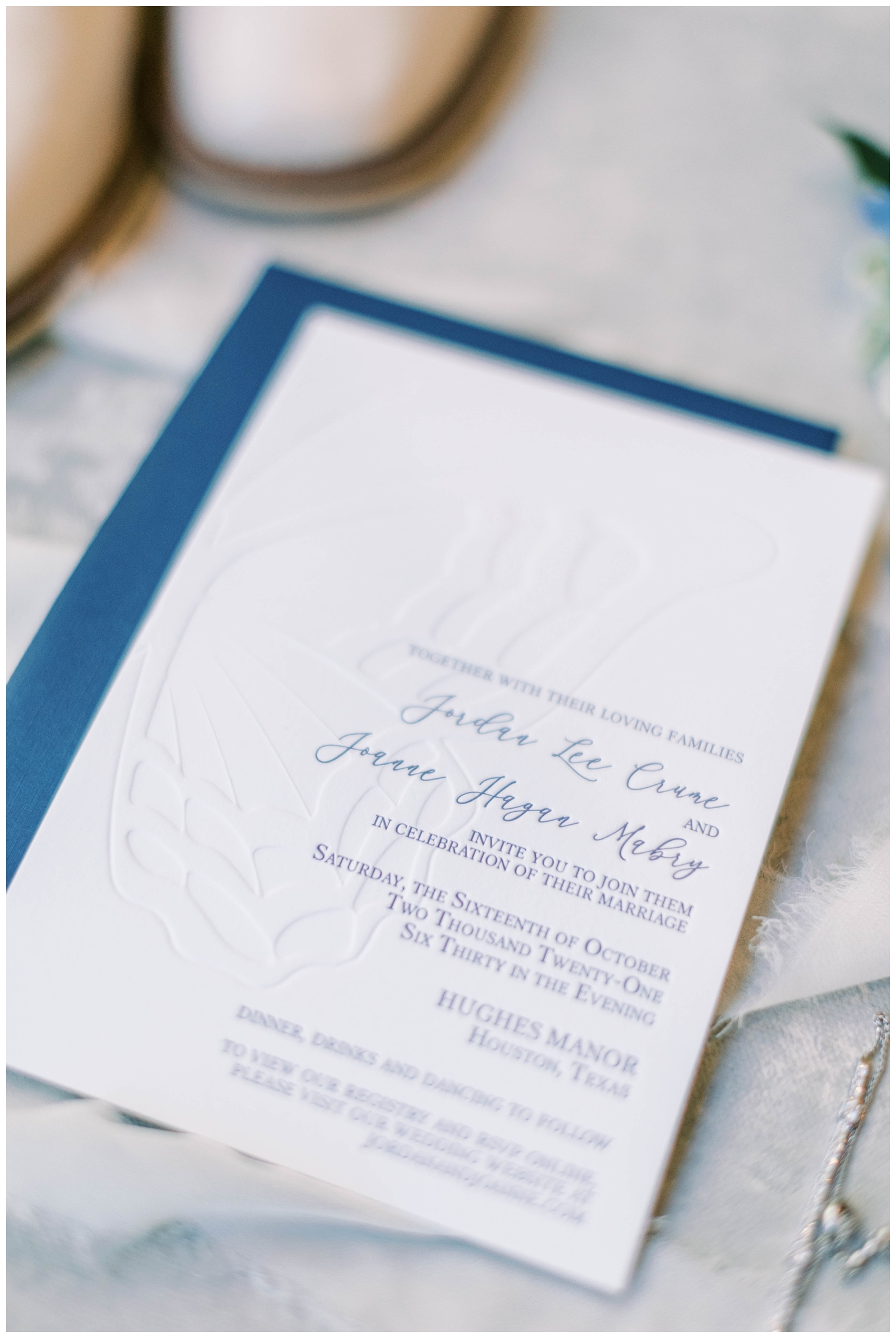 detailed shot blue and white wedding invitation
