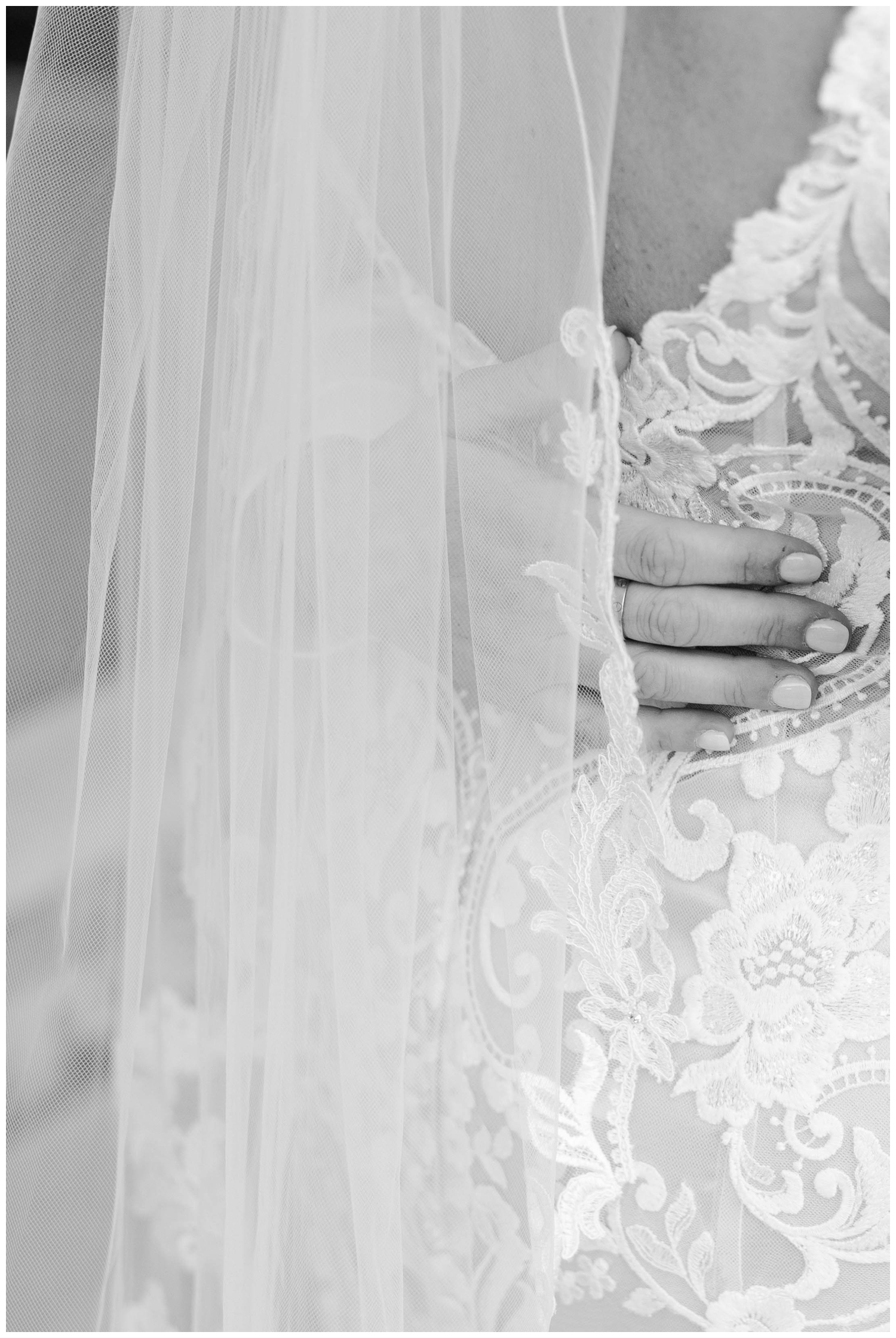 detailed imaged of hand on back of bride's dress