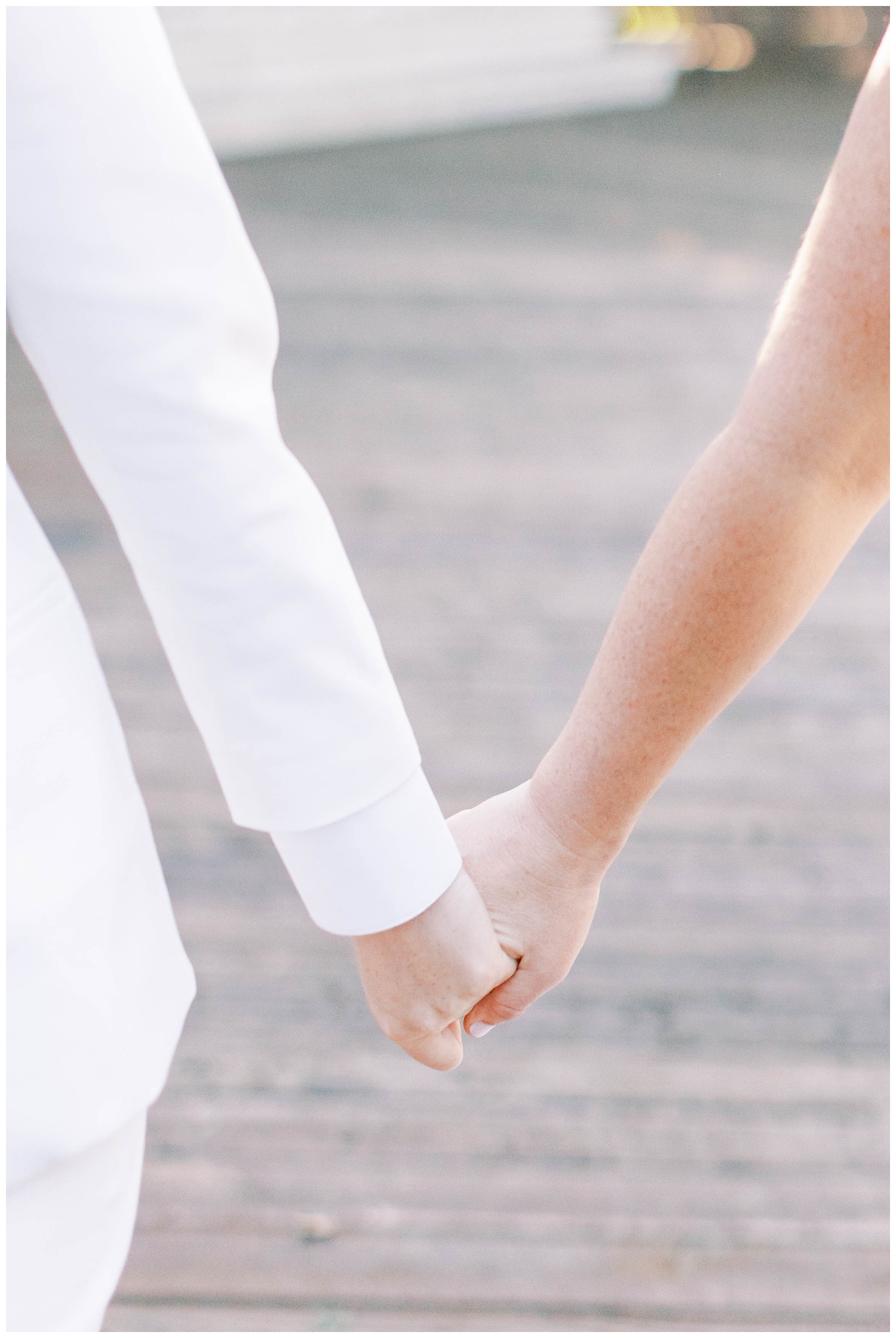 detailed image of bride and bride holding hands