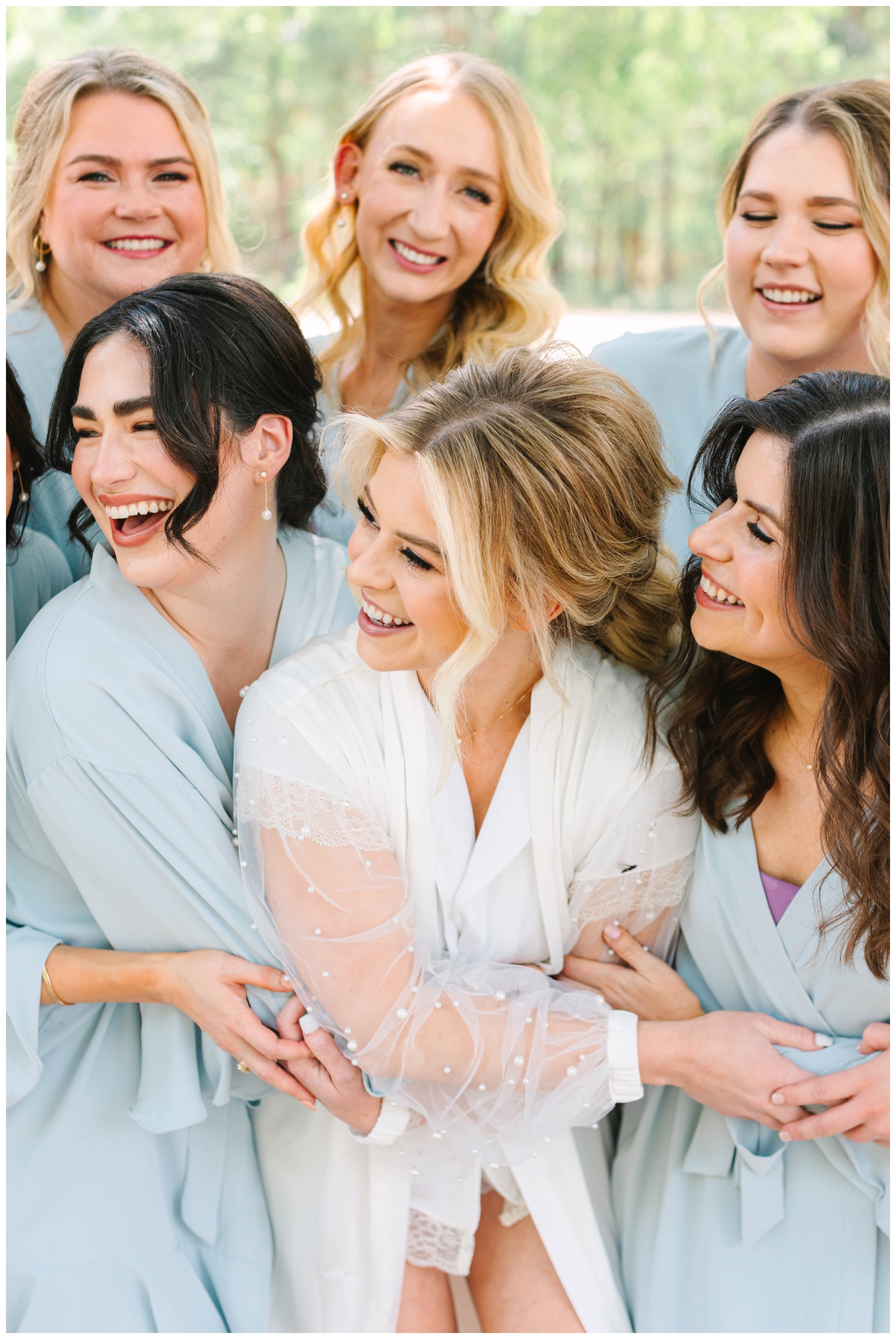 bride laughing with bridesmaids inside the Peach Orchard bridal suite