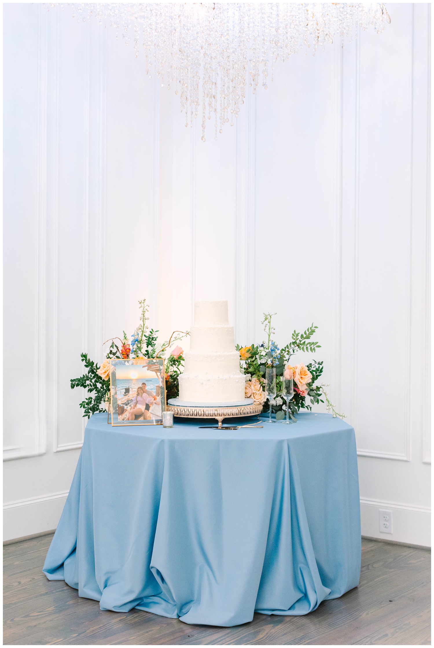 white tiered cake on blue tablecloth