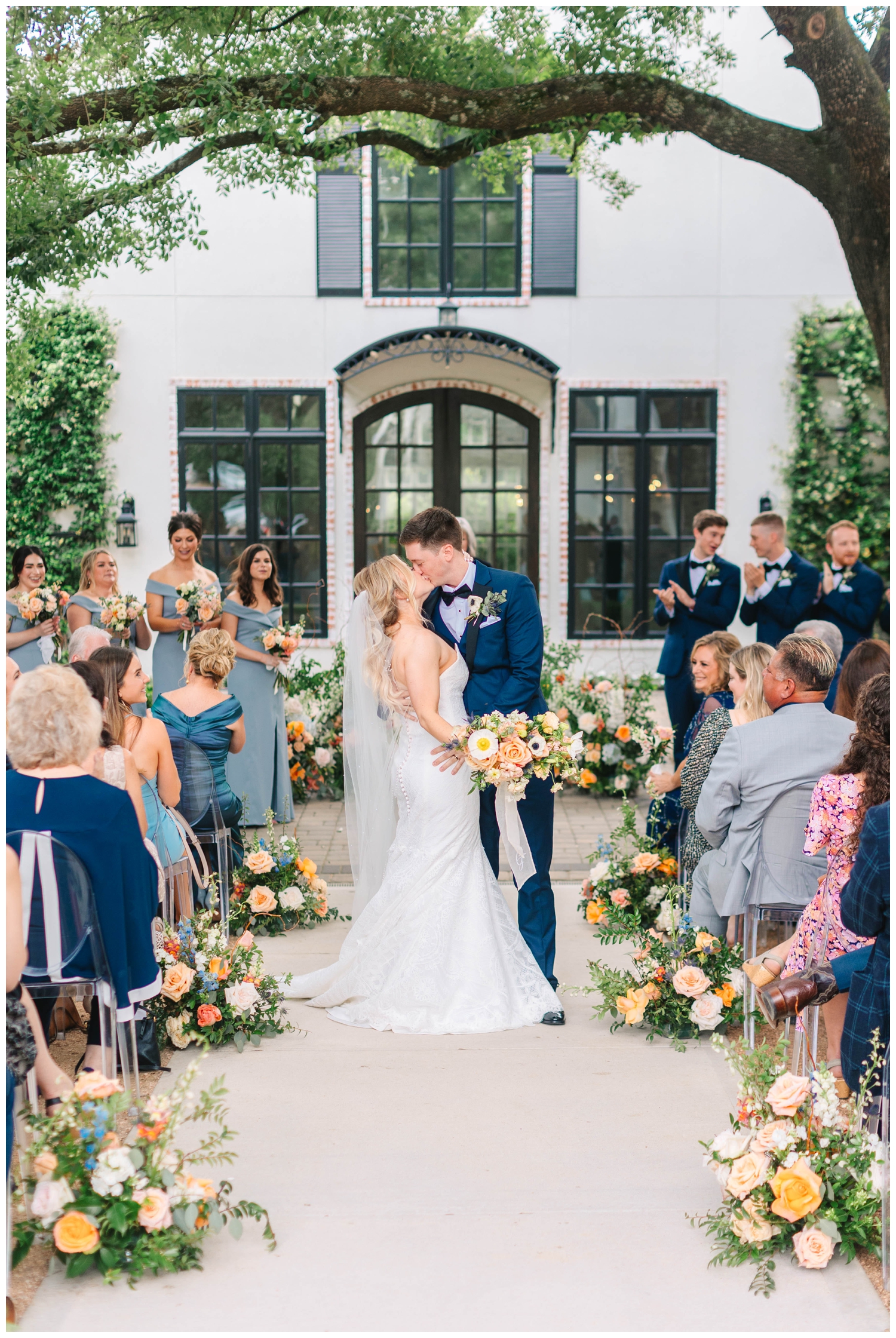 ceremony kiss between bride and groom at The Peach Orchard Wedding Venue
