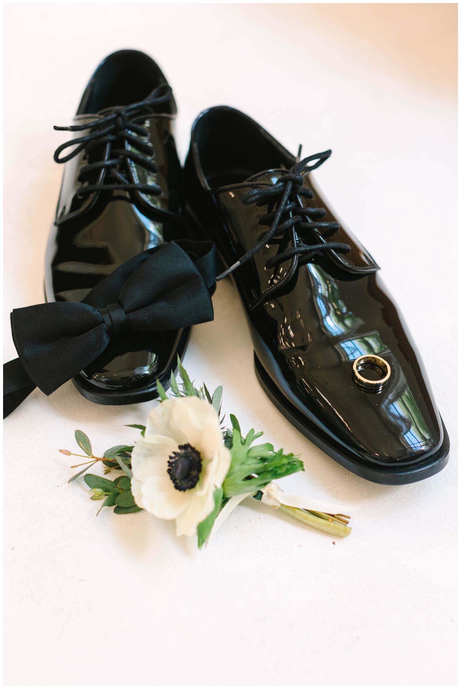 groom black shoes and bow tie details flatlay