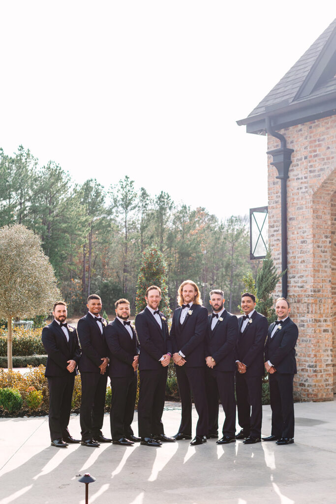 Groom and groomsmen posing for photos from wedding in Houston Texas