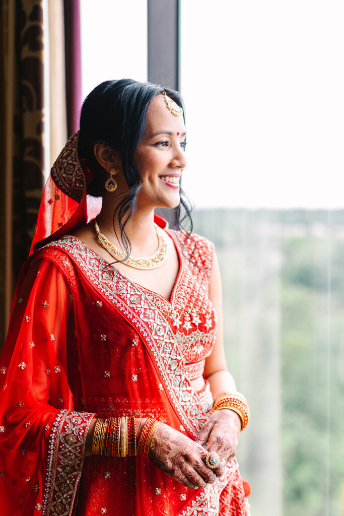 South Asian bride getting ready before wedding at Omni Hotel in Houston