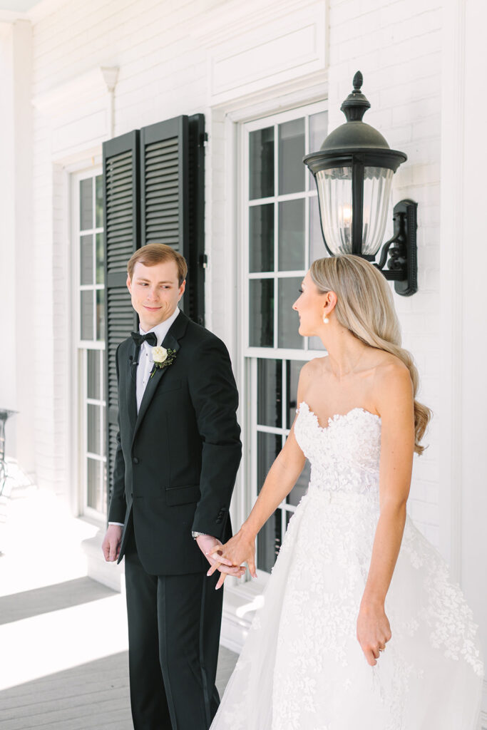Bride and grooms first touch and first looks outside of Sandlewood Manor Houston wedding venue