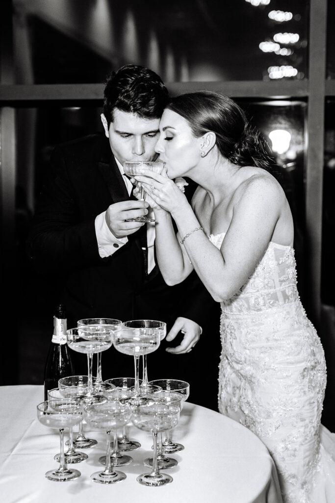 Bride and groom pouring a champagne tower at their wedding 