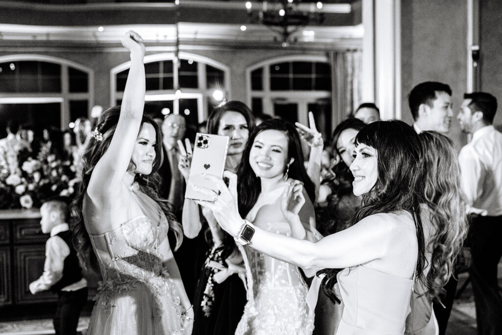 Bride taking a selfie with guests