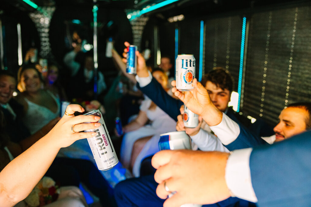 Bride and groom with wedding party on party bus
