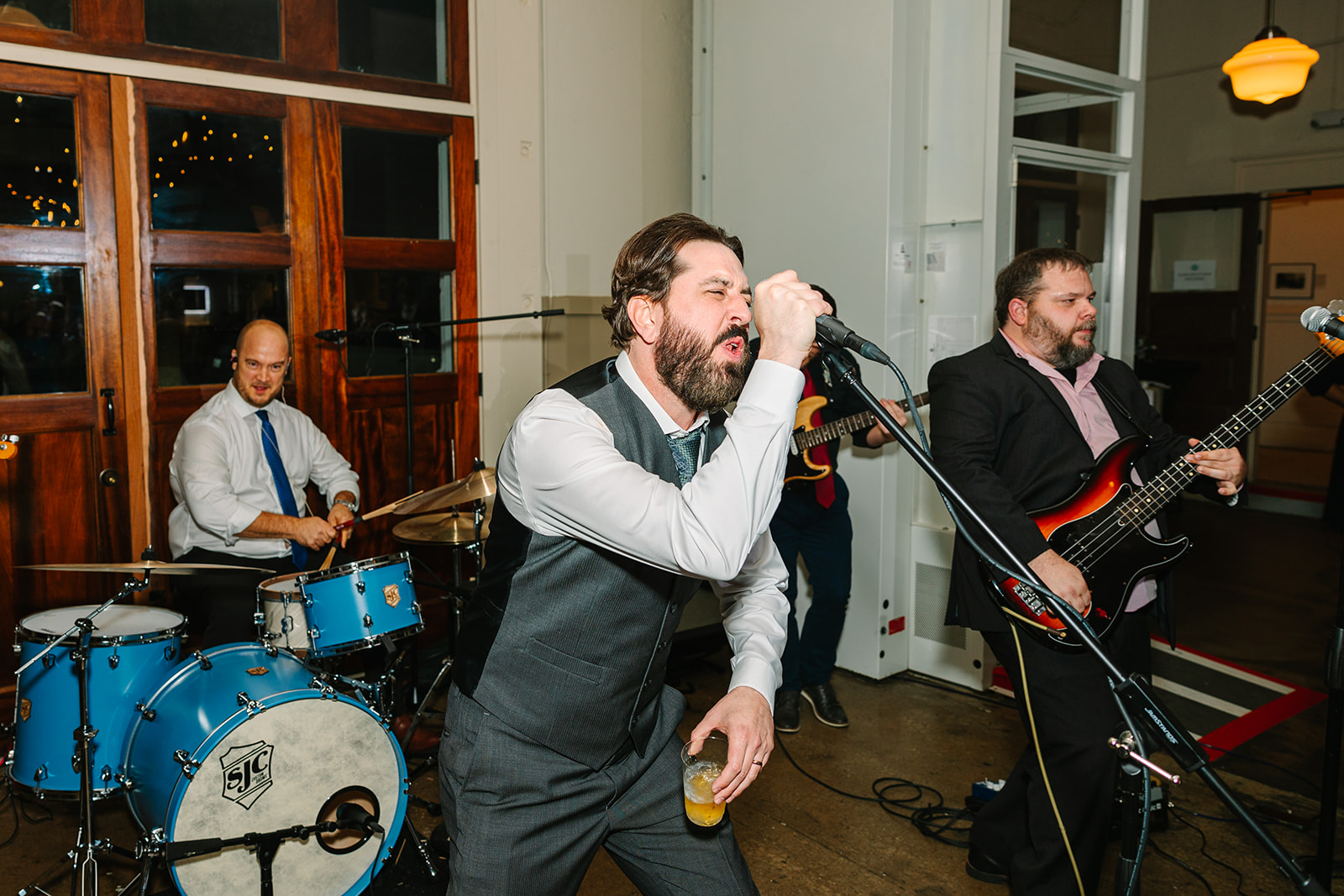 Groom singing with his band during wedding reception