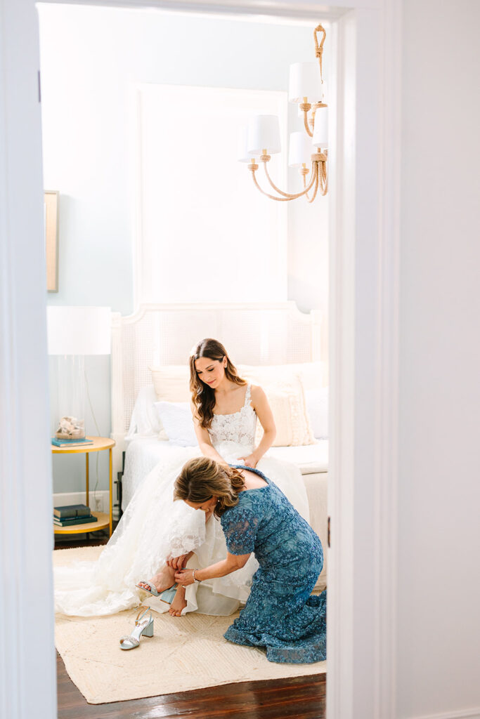 brides mother putting her shoes on