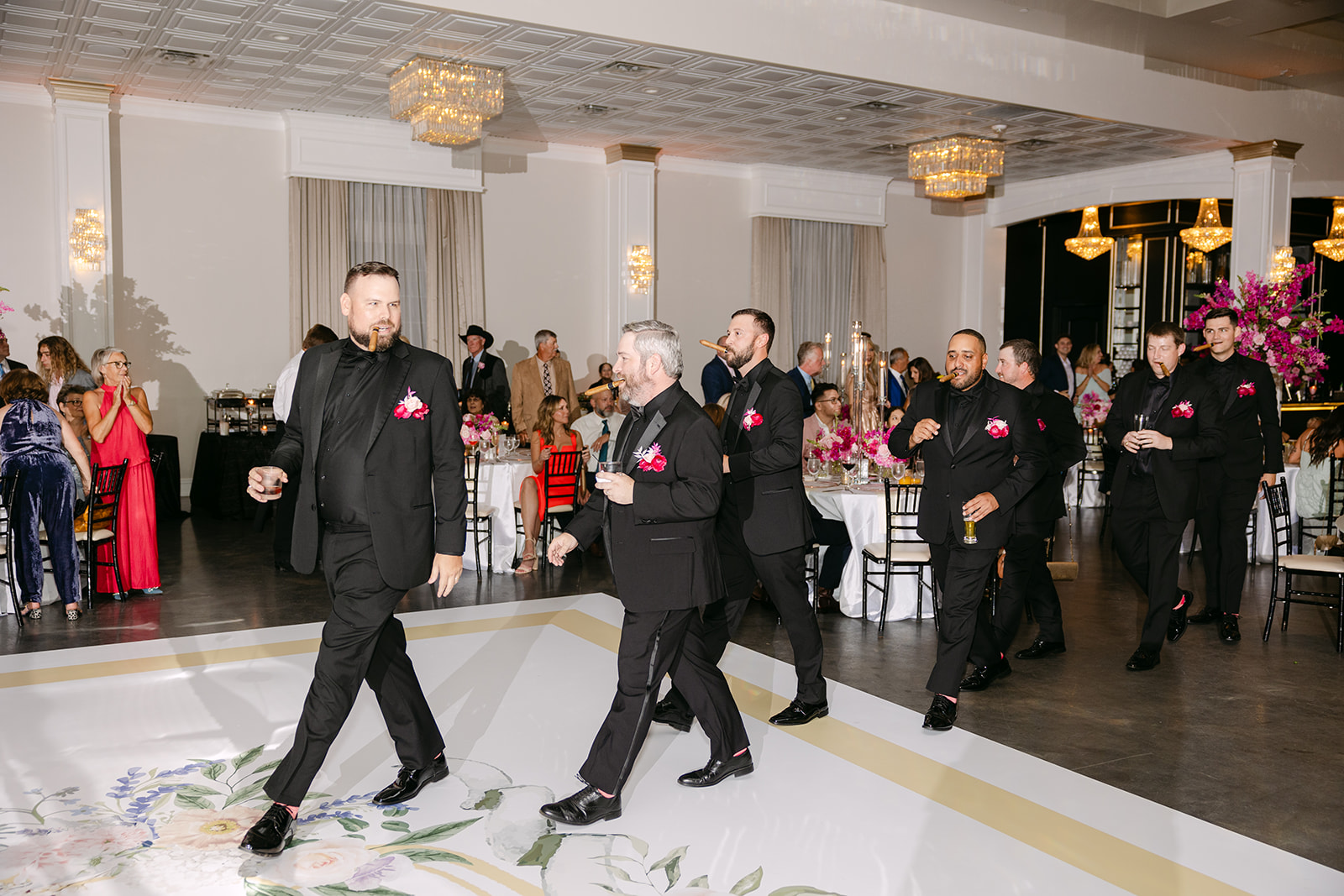 a group of people dancing on a dancefloor for a wedding