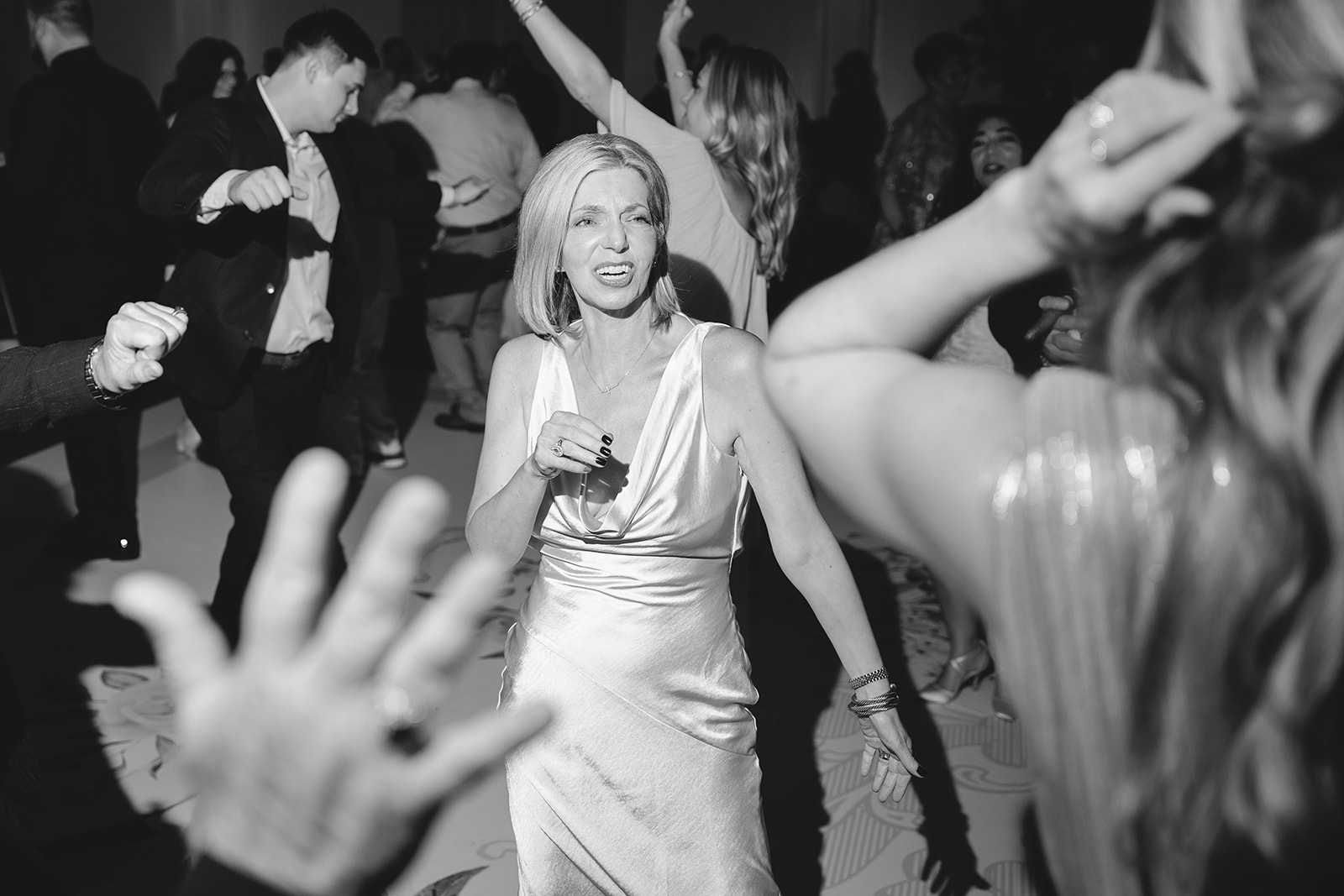 a group of people dancing on a dancefloor for a wedding