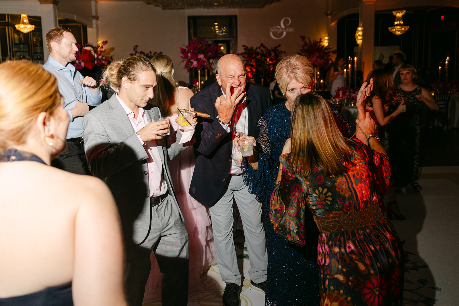 a group of people dancing on a dancefloor for a wedding