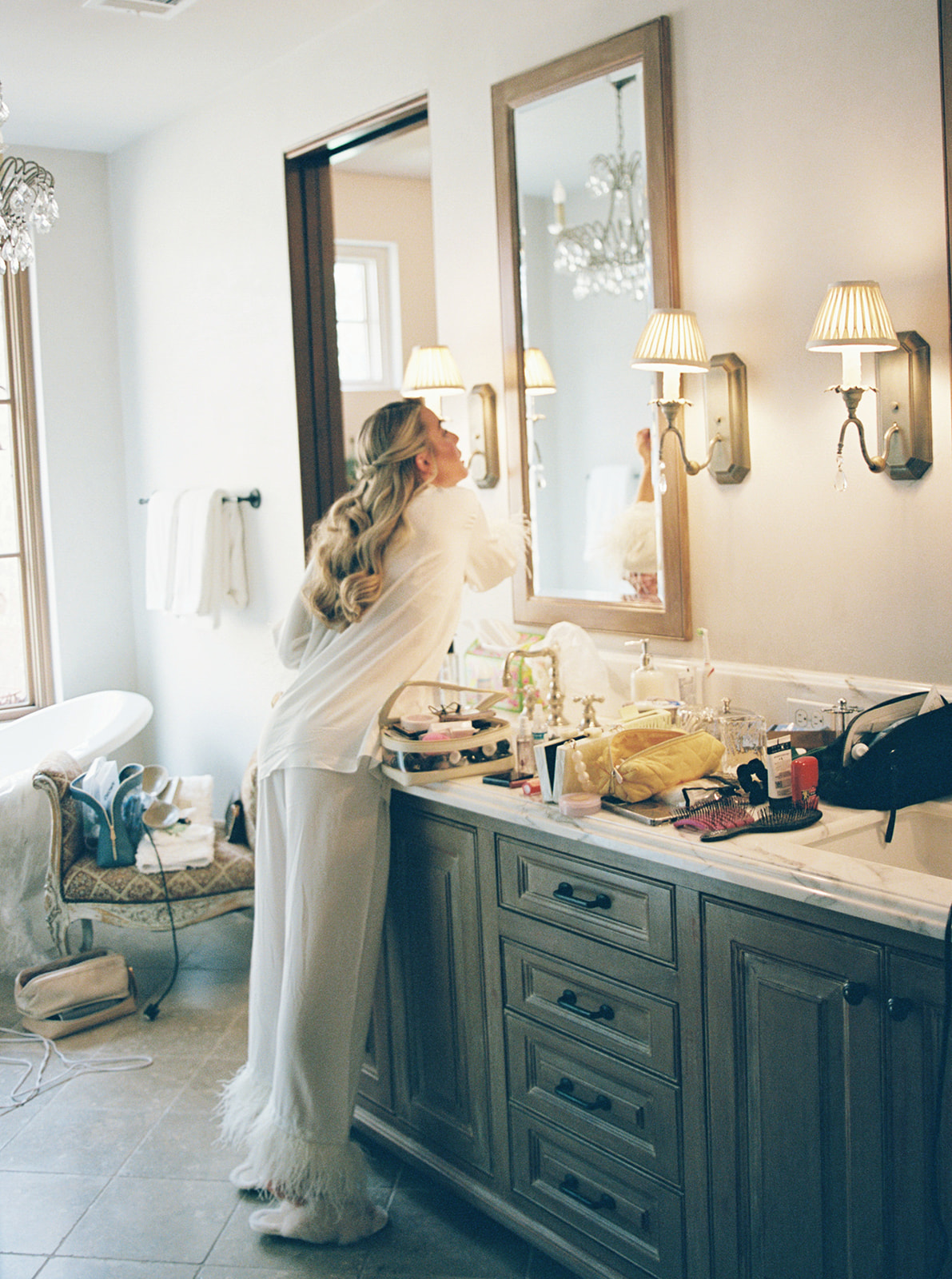 bride getting ready for her wedding with her bridesmaids