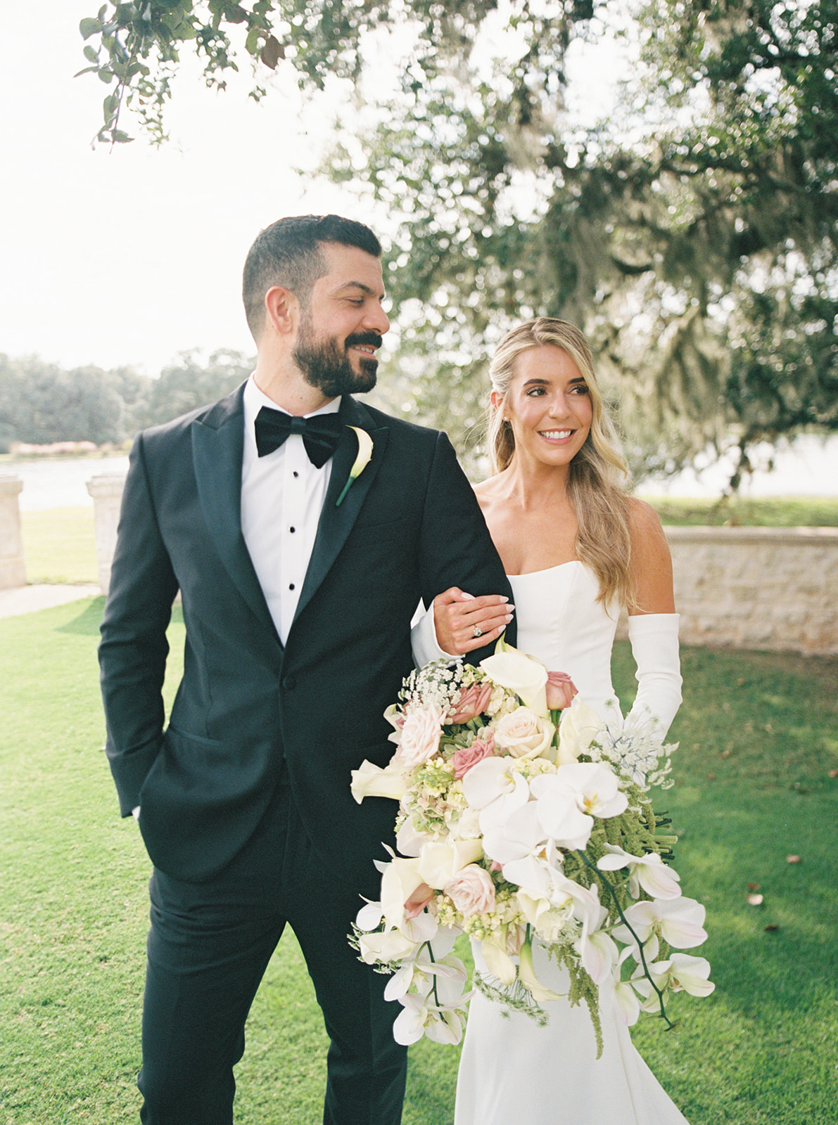 Bride and groom take wedding portraits at their wedding at The Houston Oaks Country Club