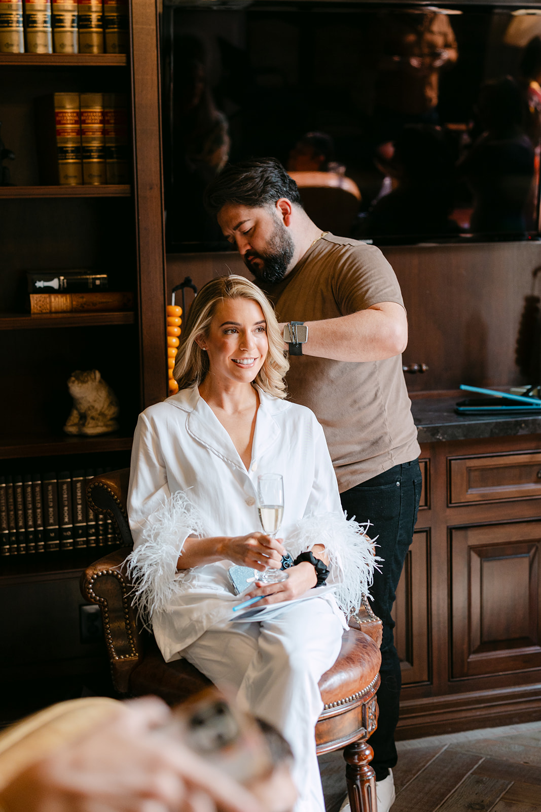 bride getting ready for her wedding with her bridesmaids