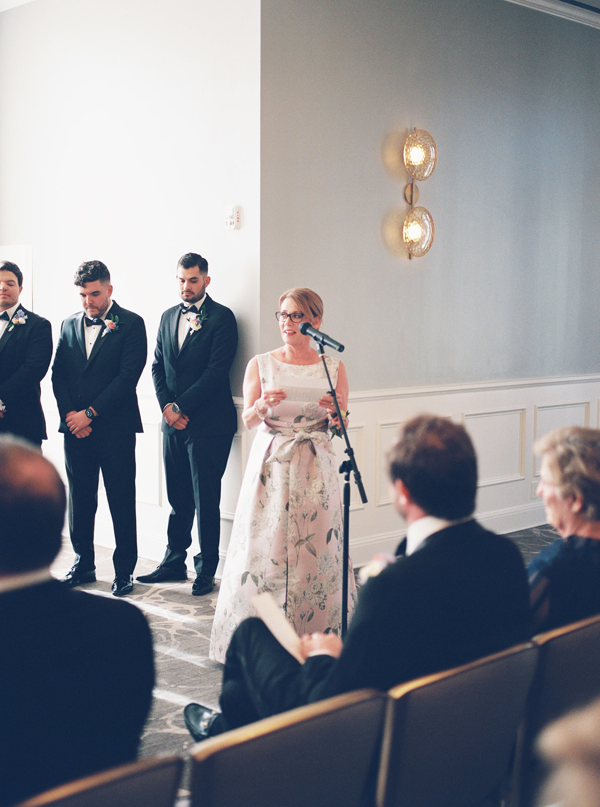 A wedding ceremony indoors with guests nearby at the tremont house
