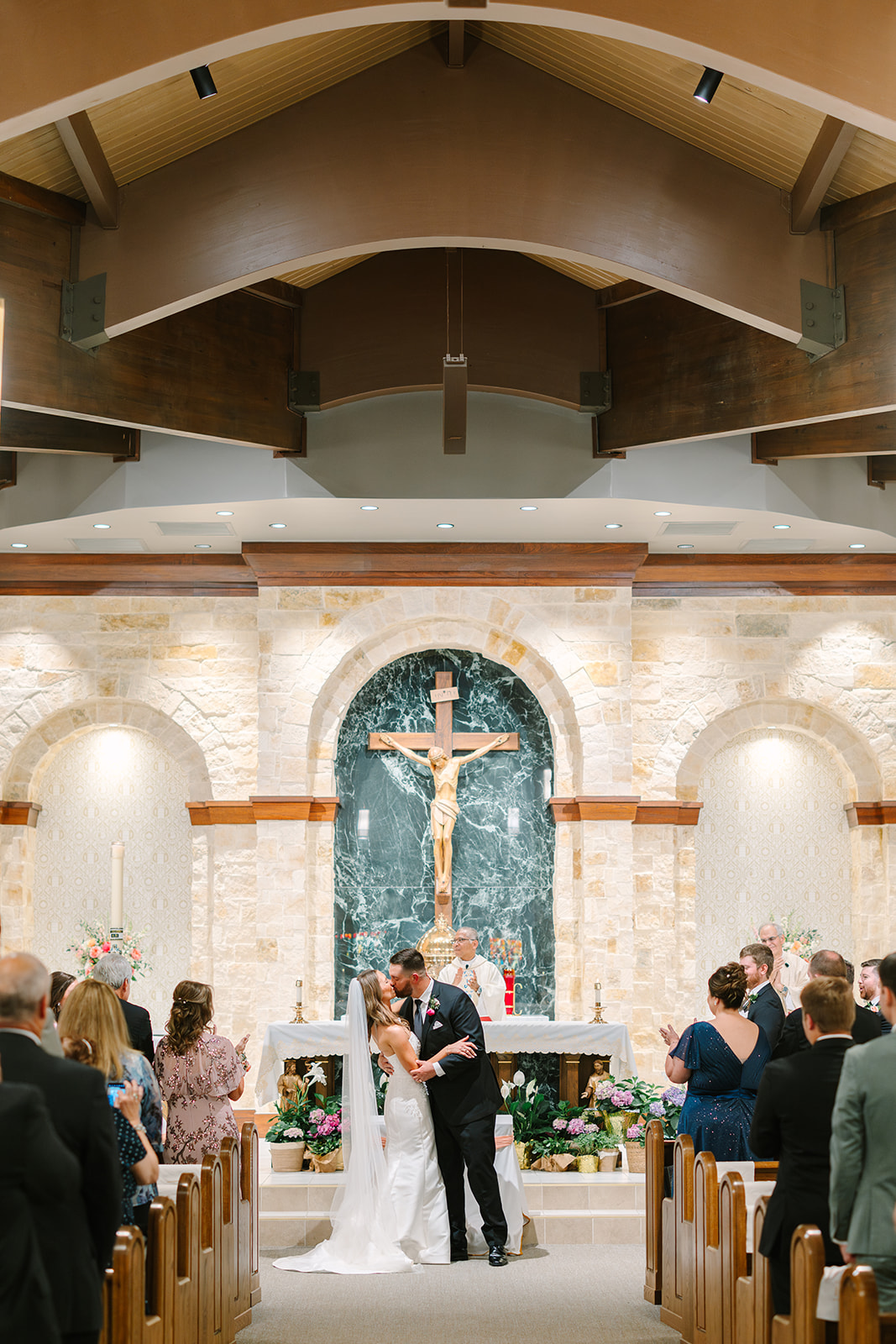 a pink summer wedding ceremony at a catholic church while a bride walks down the aisle