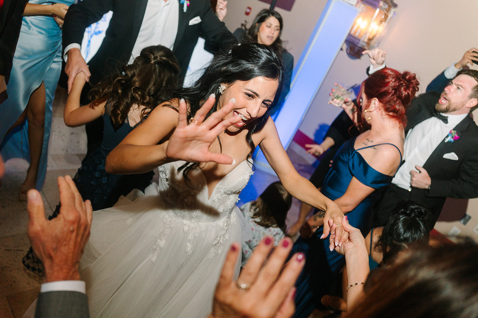 a group of people dance on the dance floor with peoples hands up