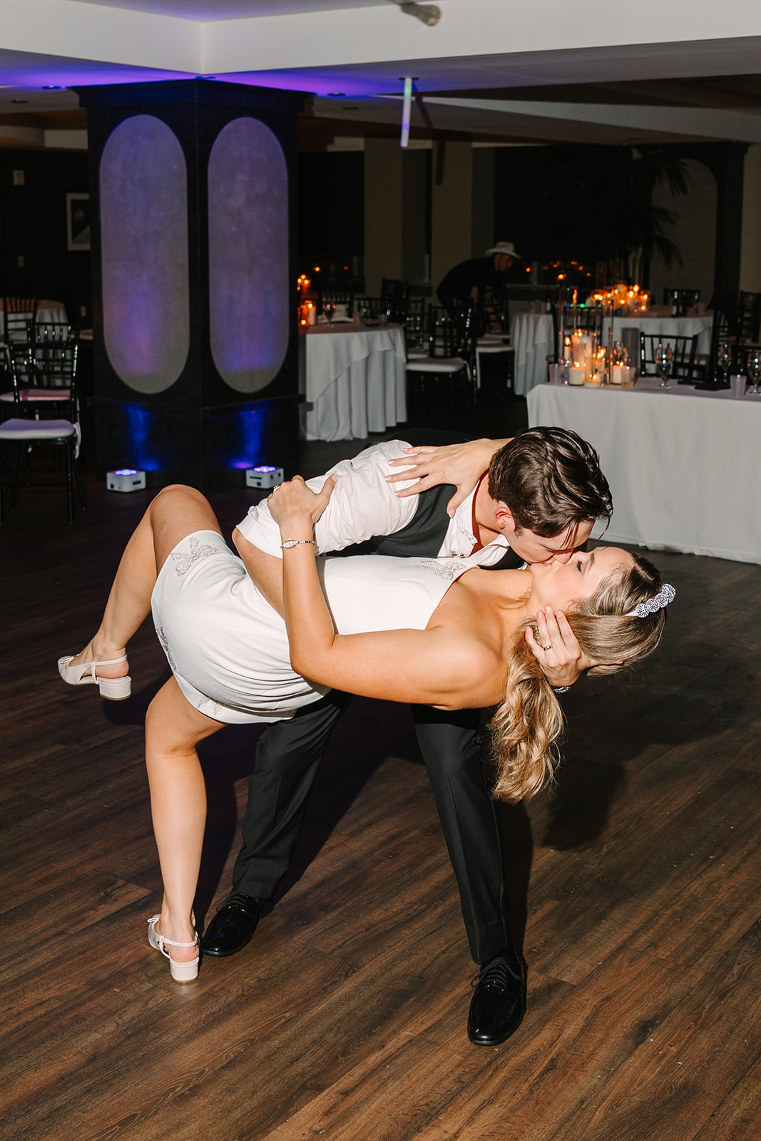 A group pf people dance on the dance floor for a wedding at Magnolia Hotel in Houston