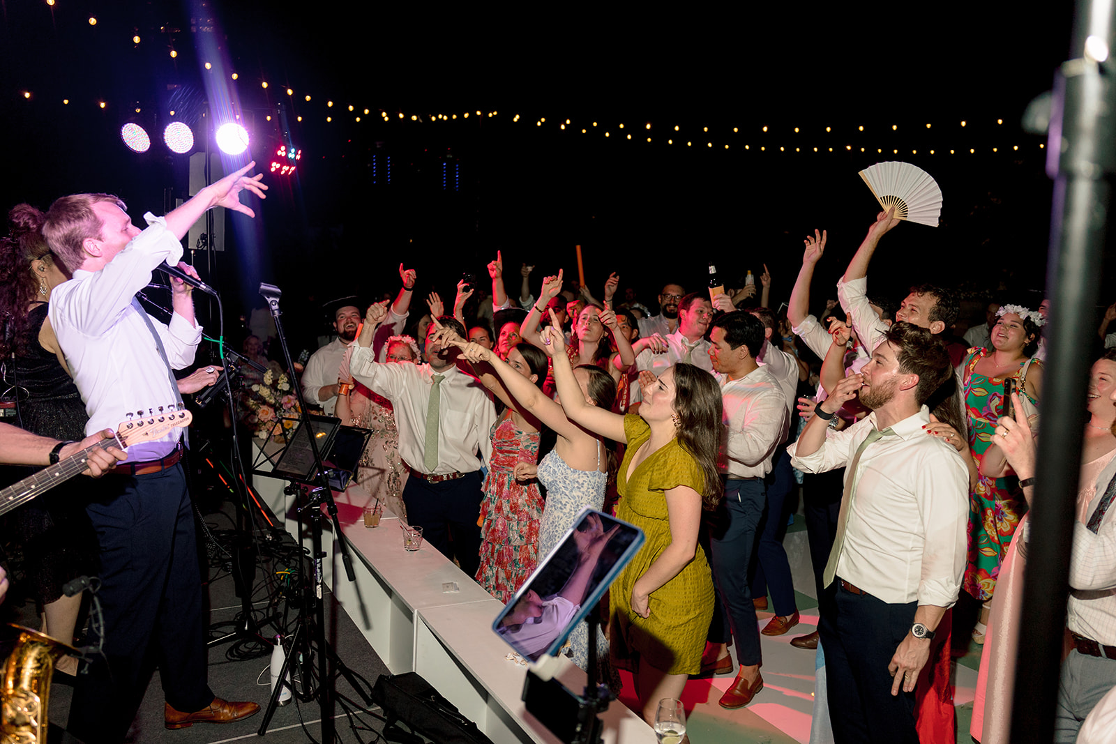 People dance together at a lively indoor event. 
