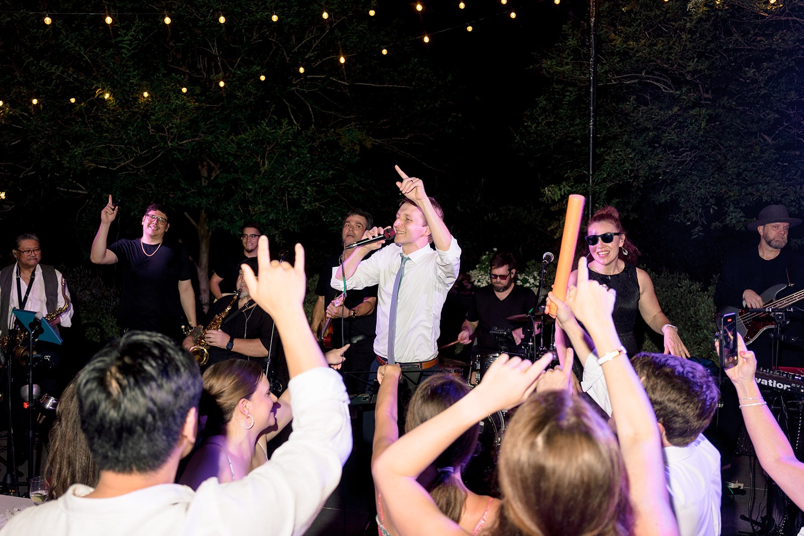 People dance together at a lively indoor event. 