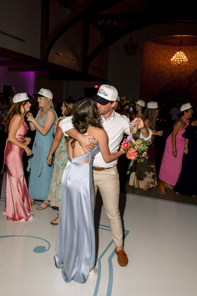 a group of people dance on the dance floor for a wedding celebration