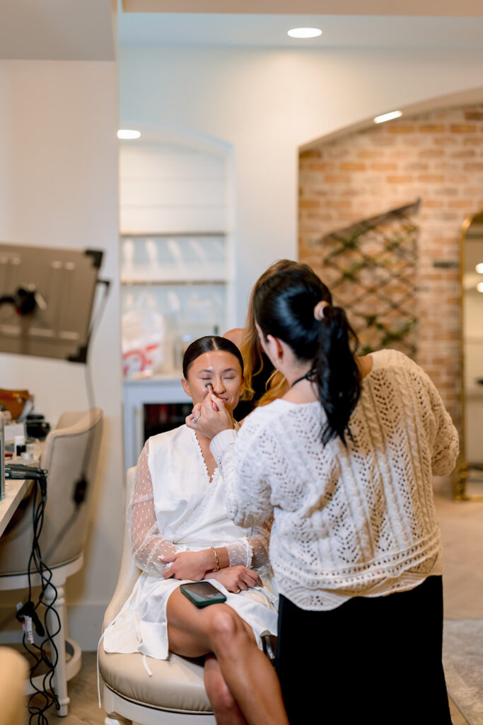 bride getting her hair done before the ceremony