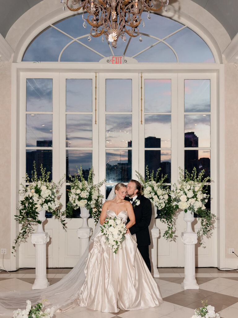 groom kissing the bride on the cheek