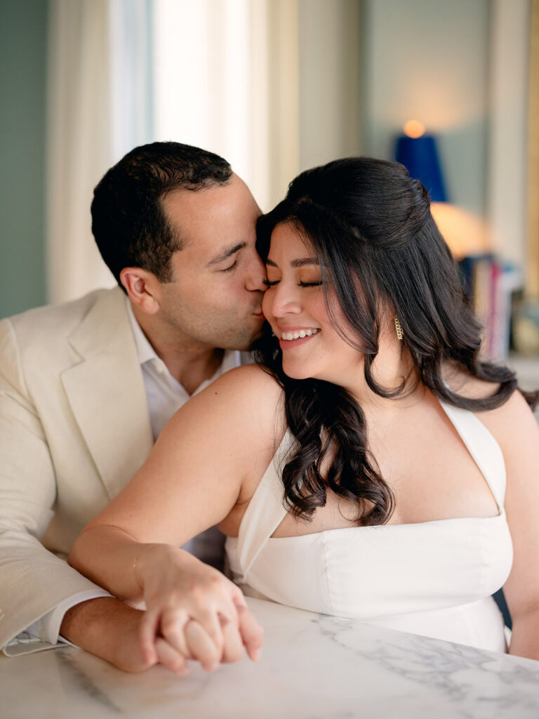 fiance kissing his fiance on the cheek