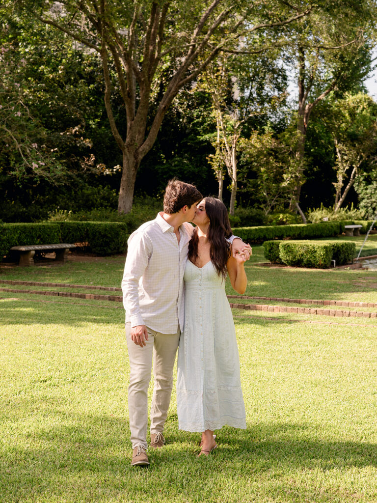Kessler and Thomas share a kiss on the garden lawn at Bayou Bend Collection and Gardens in Houston, TX