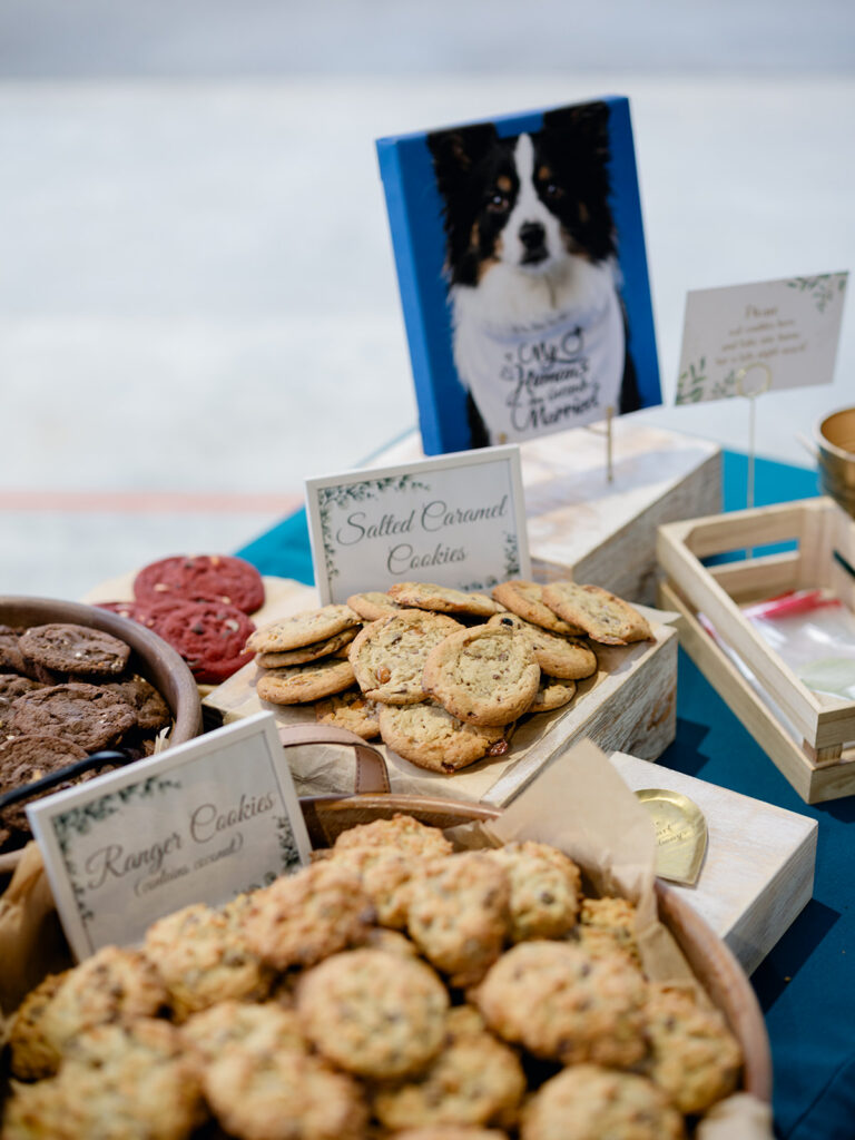 Dog portrait sign next to the rehearsal dinner cookie bar
