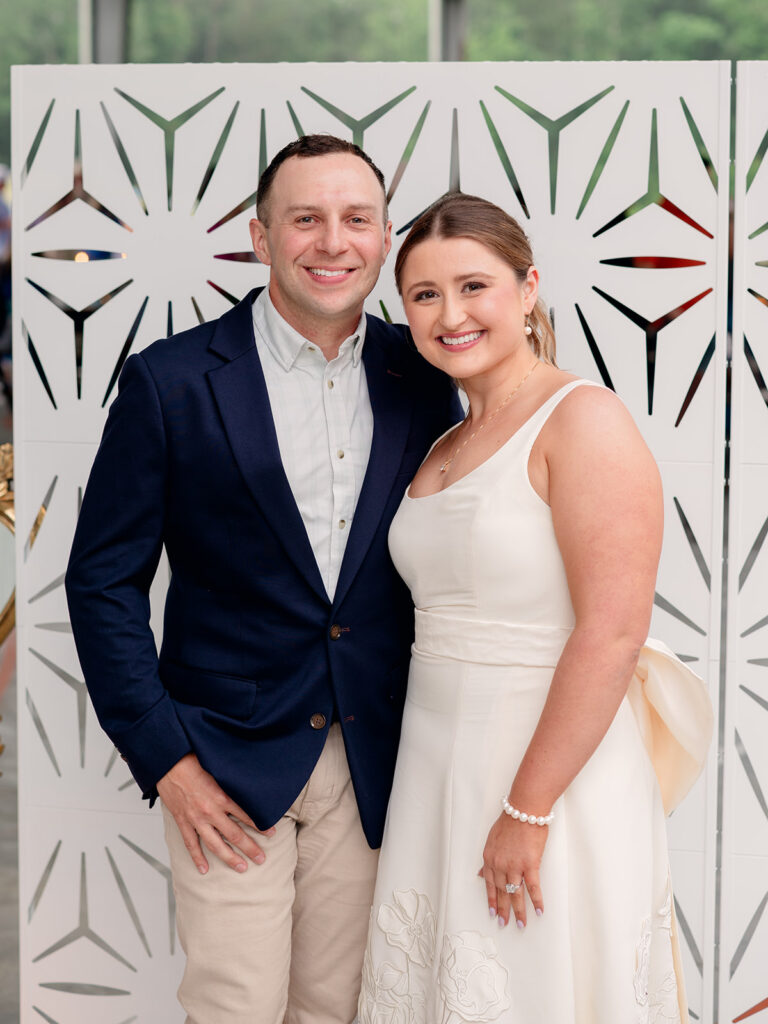 Bride in a white dress and groom in a navy blazer at their rehearsal dinner