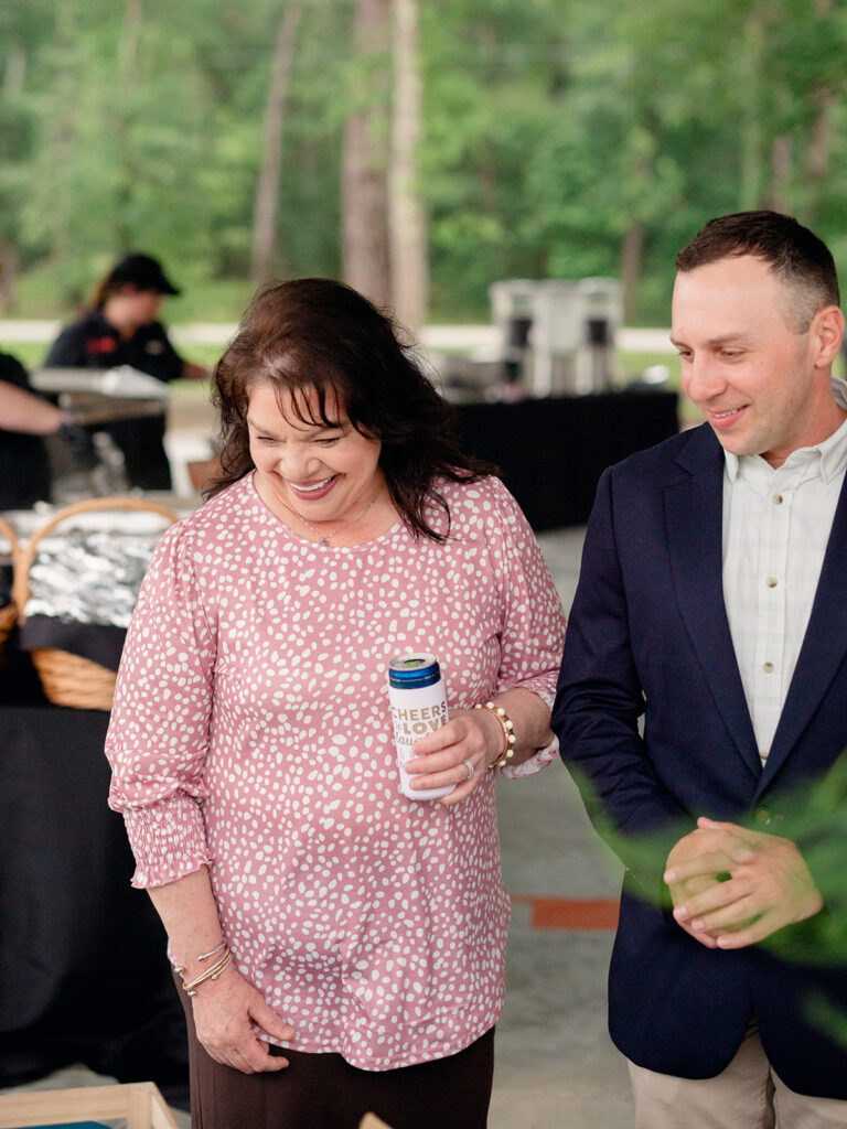 Groom sharing a laugh with family at the rehearsal dinner