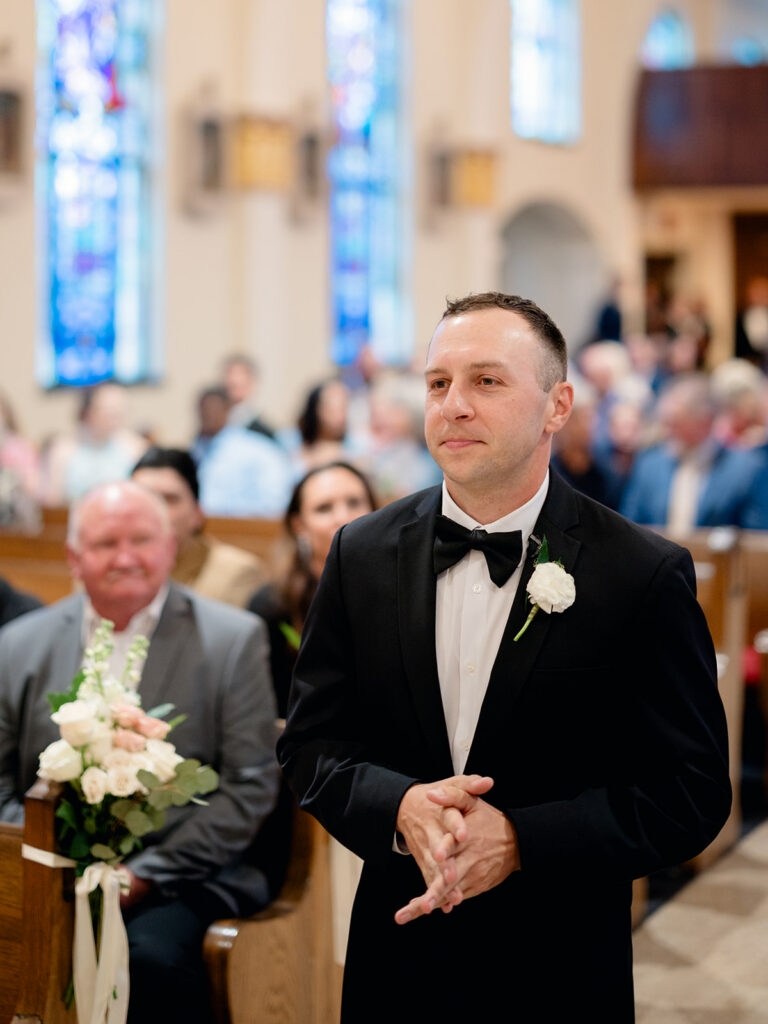 Groom waiting at the front of the church for his bride