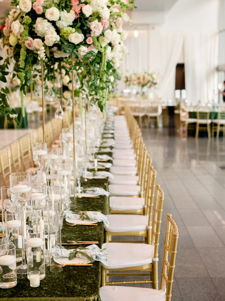 Long reception table with candles and towering white florals