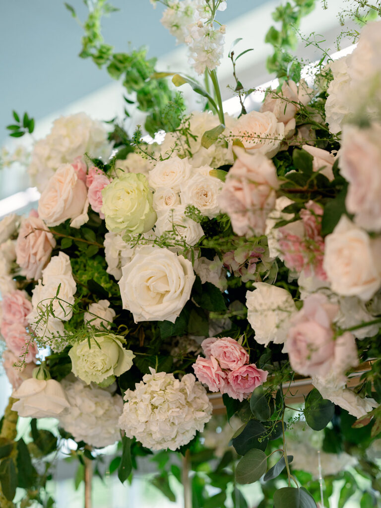 Close up of white and blush roses in the reception florals