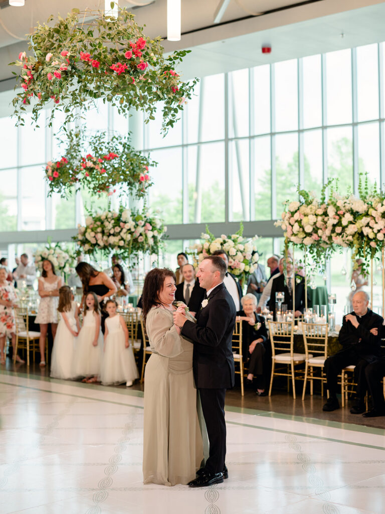 Mother son dance with flower girls watching